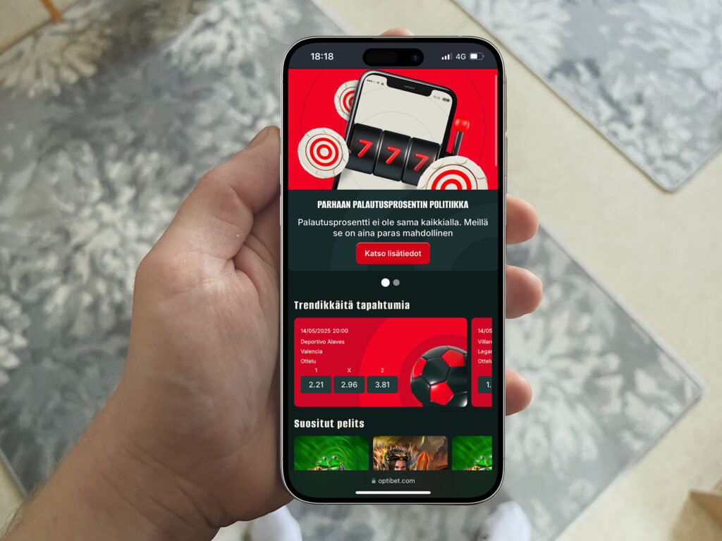 Älypuhelimen näytöllä näkyy nettikasinosivusto, jossa mainostetaan parhaan palautusprosentin politiikkaa ja esitellään vedonlyöntikohteita sekä pelejä.