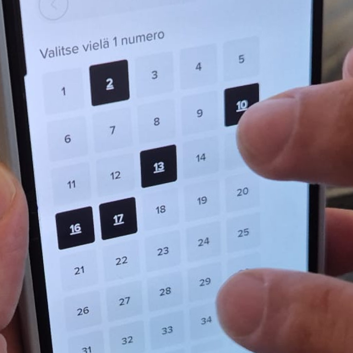 Puhelimen näytöllä käyttäjä valitsee pelinumerot ruudukosta