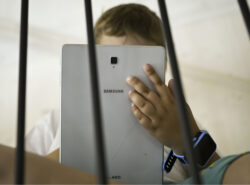 Lapsi käyttää tablettia.