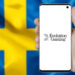 Evolution Gaming logo puhelimessa ruotsin lipun edessä.